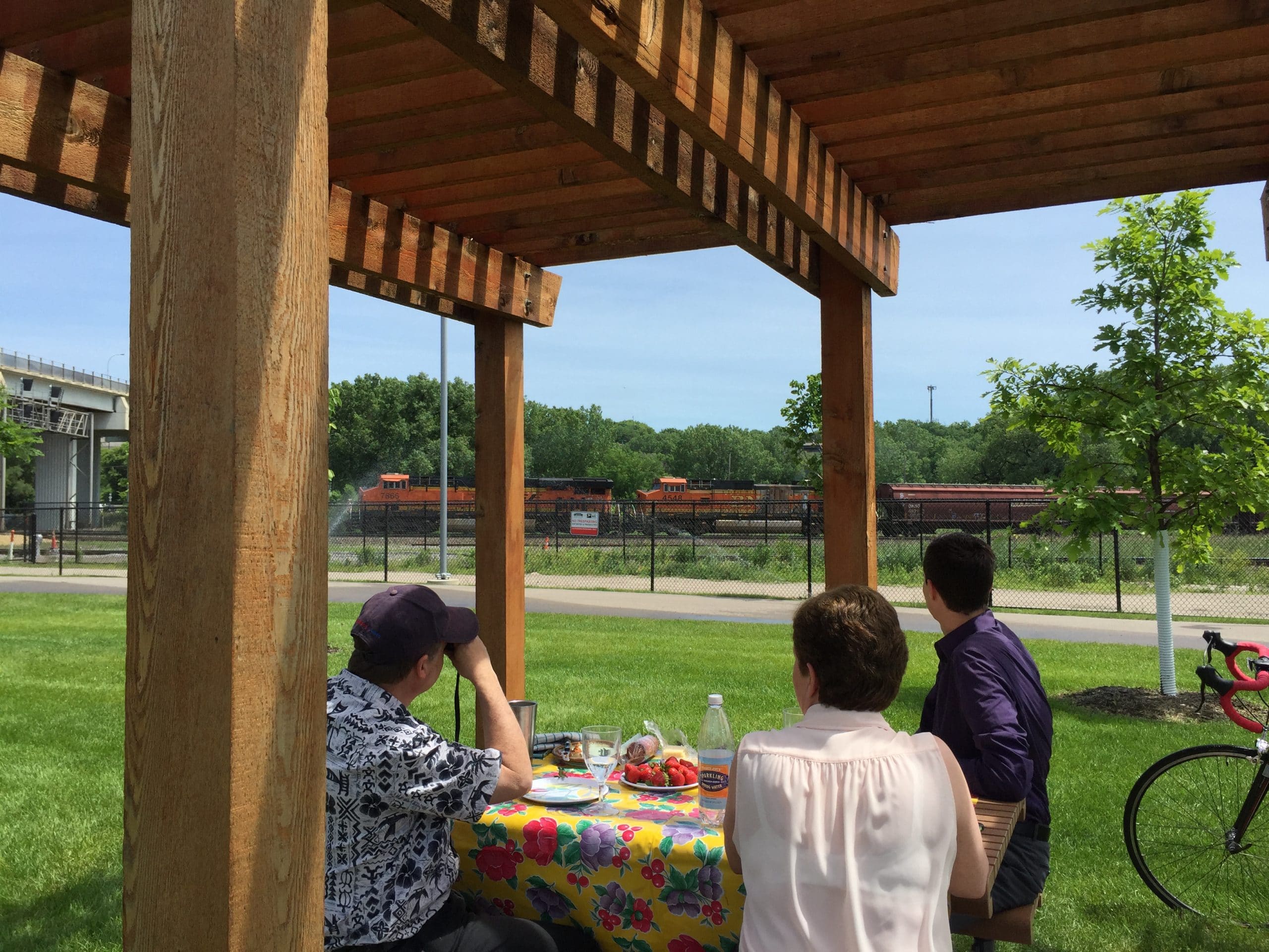 People having a picnic near train tracks