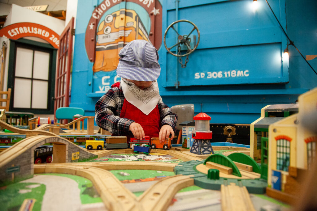 child playing at choo choo bob's train store